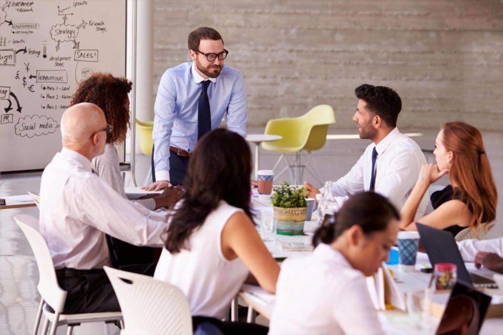 20160525134444-businessman-leading-meeting-boardroom-brainstorming-ideas-talking-collaboration-presentations